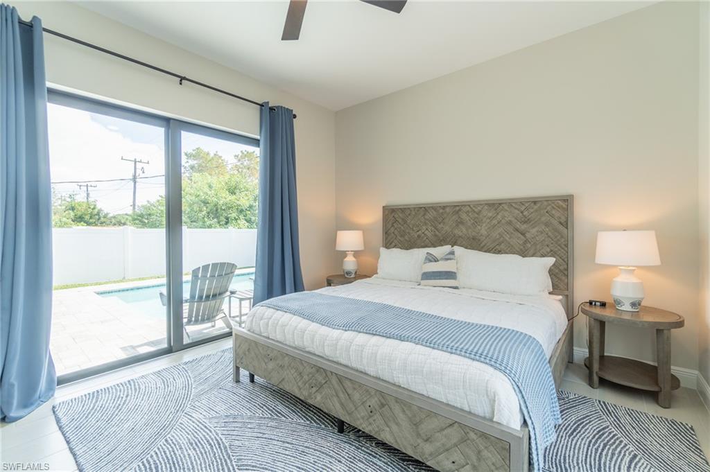 822 105th Avenue North Naples, FL 34108 - Photo 11 of 30 a bedroom with a large bed and a night stand