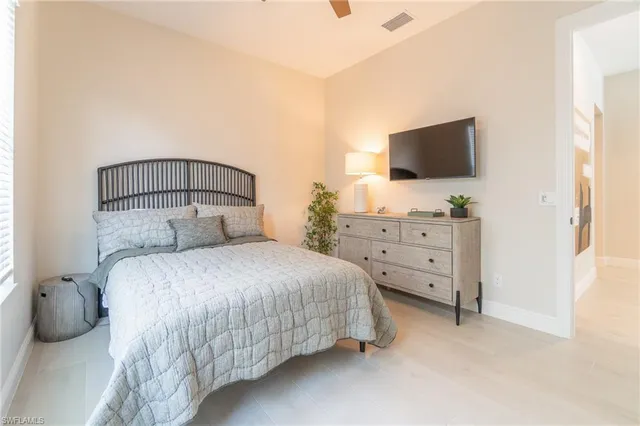 a bedroom with a bed and flat screen tv