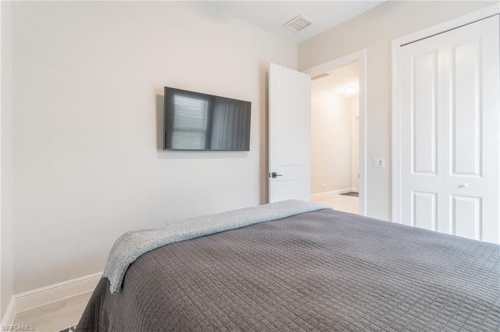 822 105th Avenue North Naples, FL 34108 - Photo 20 of 30 a bedroom with a bed and a window