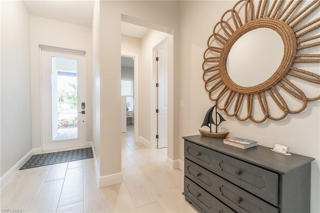 822 105th Avenue North Naples, FL 34108 - Photo 21 of 30 a bathroom with a sink a mirror and a shower