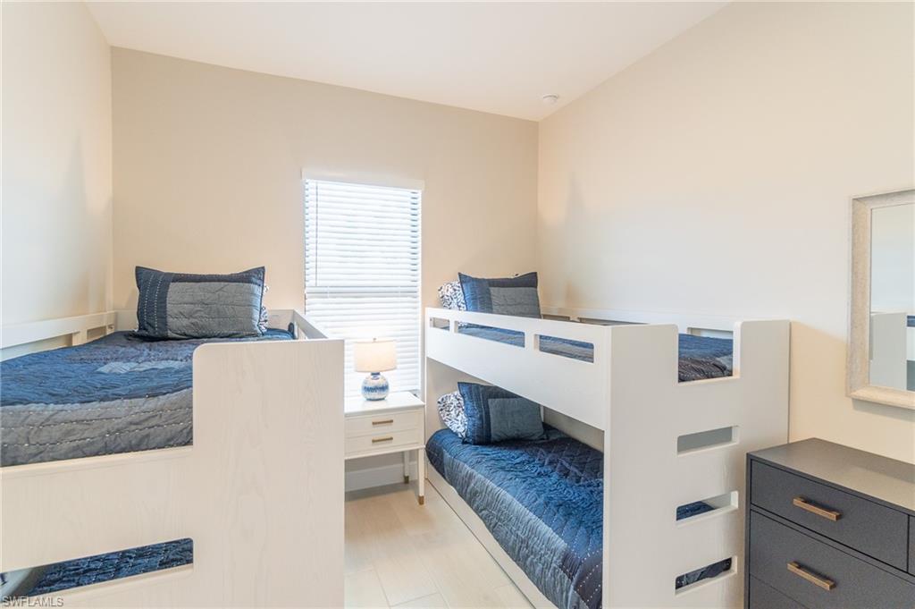 822 105th Avenue North Naples, FL 34108 - Photo 22 of 30 a living room with a couch and a table