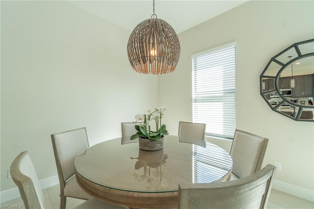 822 105th Avenue North Naples, FL 34108 - Photo 25 of 30 a view of a dining room with furniture and wooden floor
