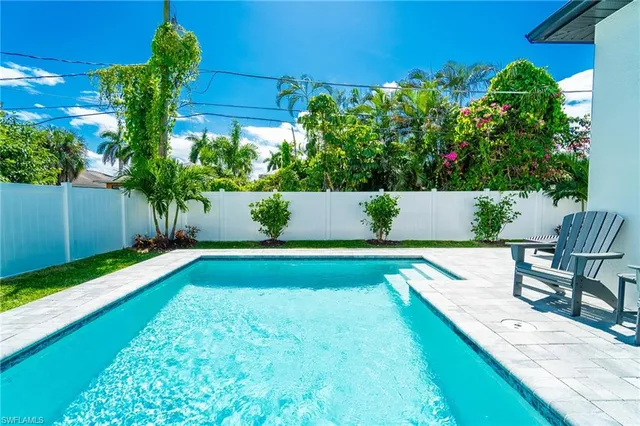 a view of yard with swimming pool and green space