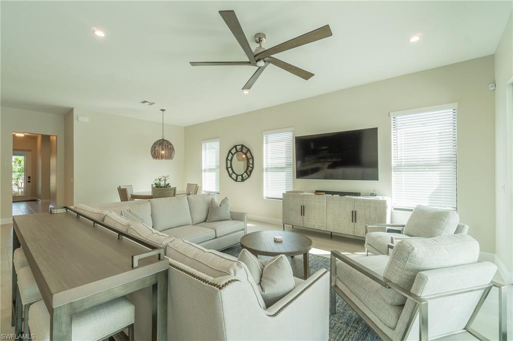 822 105th Avenue North Naples, FL 34108 - Photo 3 of 30 a living room with furniture and a flat screen tv