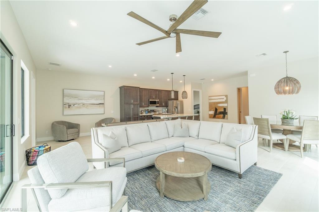 822 105th Avenue North Naples, FL 34108 - Photo 5 of 30 a living room with furniture and a view of kitchen