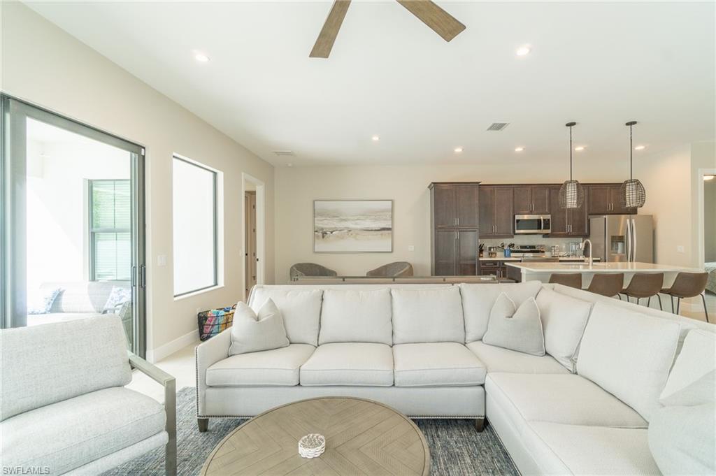 822 105th Avenue North Naples, FL 34108 - Photo 7 of 30 a living room with furniture and a large window