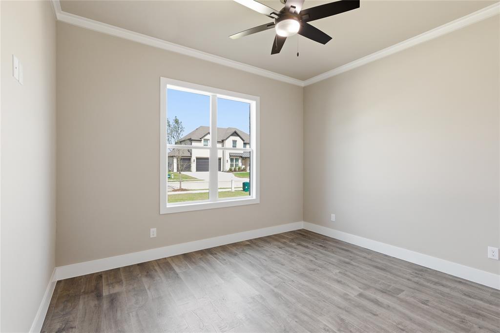 709 Anne Road Van Alstyne, TX 75495 - Photo 15 of 28 Neutral-toned interior featuring wood-finish flooring and a ceiling fan with integrated lighting