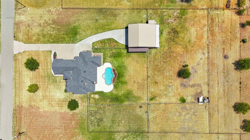 420 Hartley Way Azle, TX 76020 - Photo 39 of 40 Paved driveway leading to a multi-level roofline residence with a swimming pool and a separate detached building