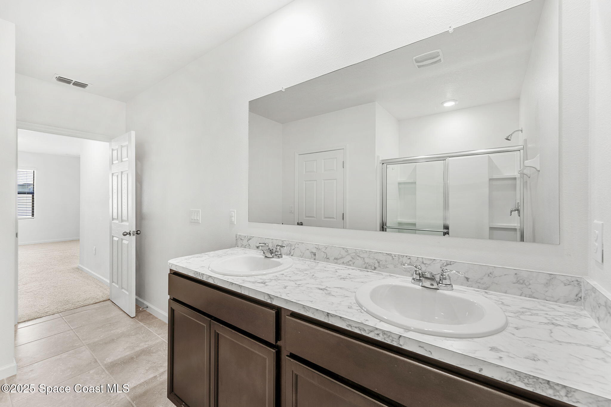 4667 Magenta Isles Drive Melbourne, FL 32904 - Photo 12 of 29 a bathroom with a sink and a mirror