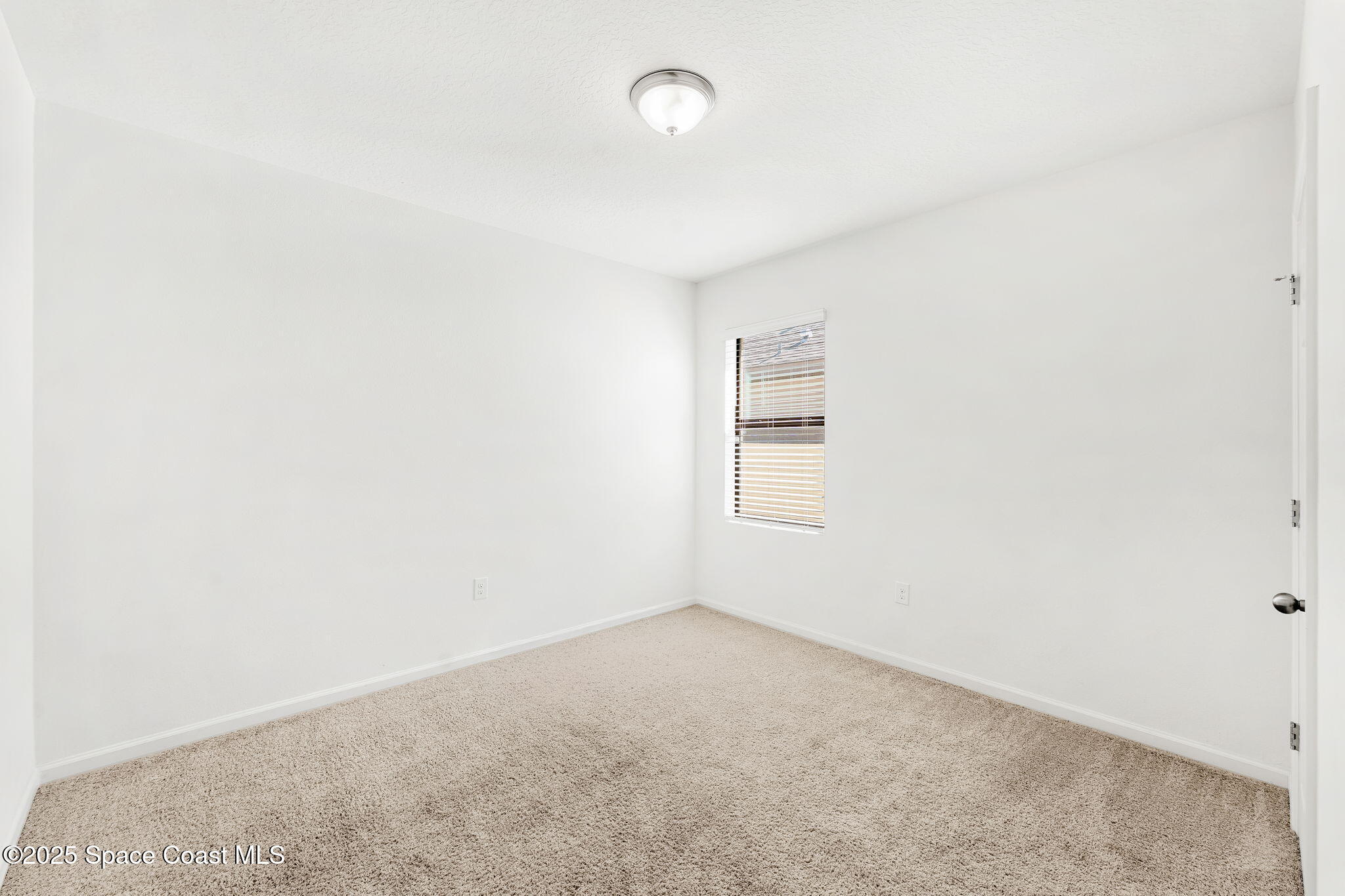 4667 Magenta Isles Drive Melbourne, FL 32904 - Photo 13 of 29 an empty room with a window