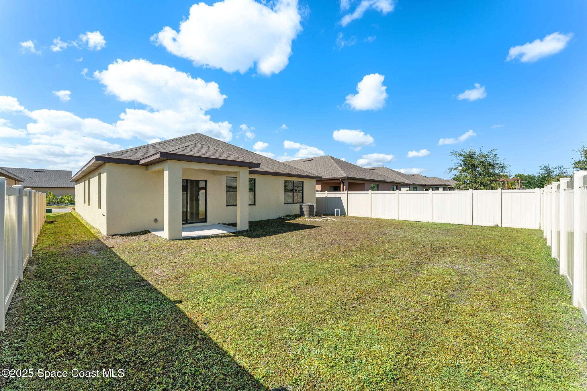 4667 Magenta Isles Drive Melbourne, FL 32904 - Photo 18 of 29 a view of a house with a backyard and porch
