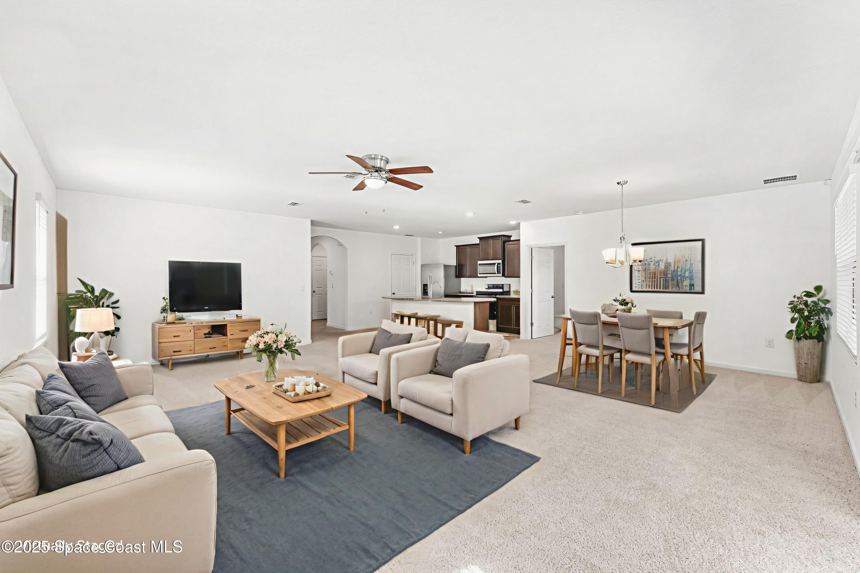 4667 Magenta Isles Drive Melbourne, FL 32904 - Photo 2 of 29 a living room with furniture and a flat screen tv