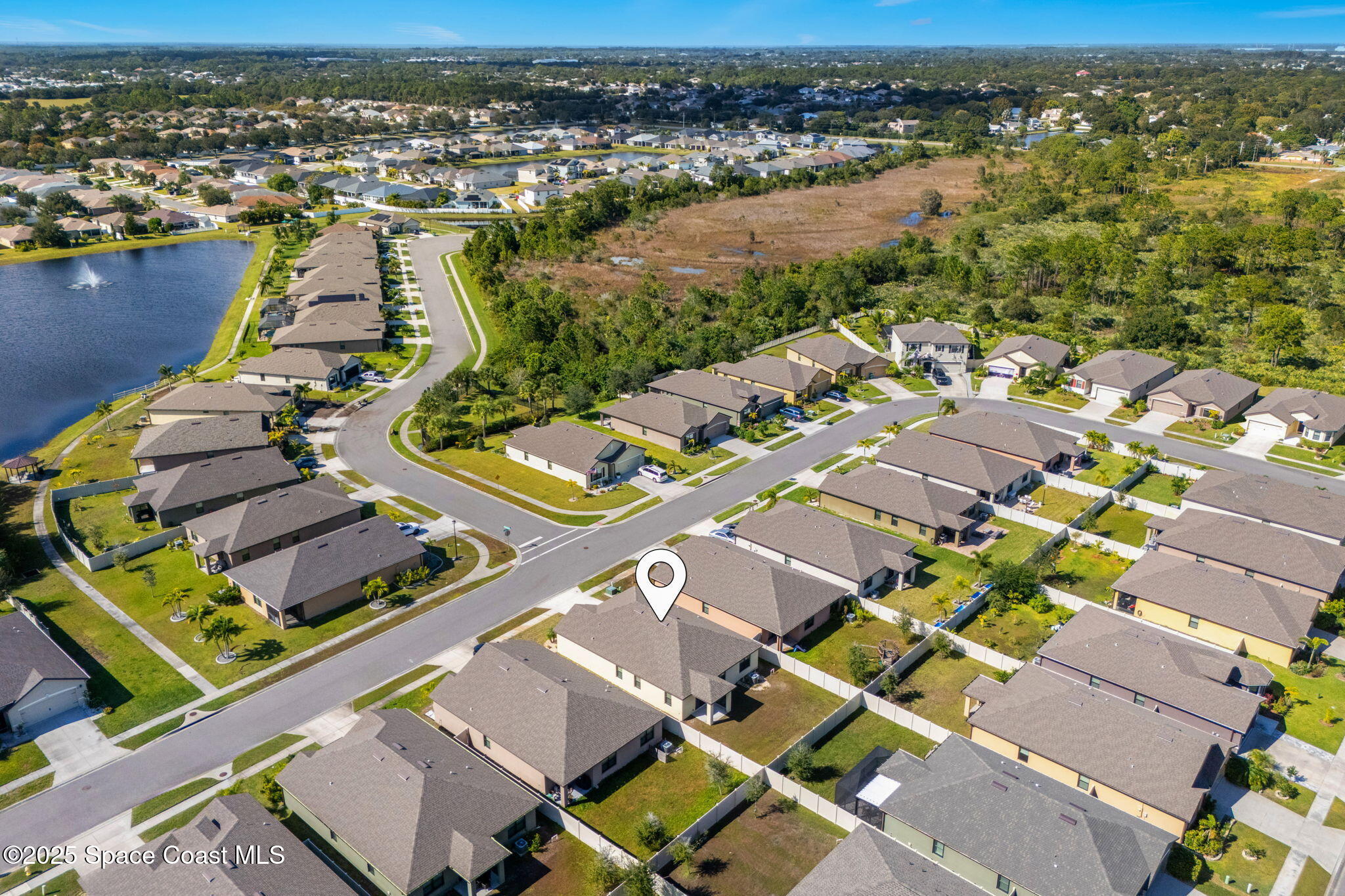 4667 Magenta Isles Drive Melbourne, FL 32904 - Photo 25 of 29 an aerial view of a city with lots of residential buildings and ocean view
