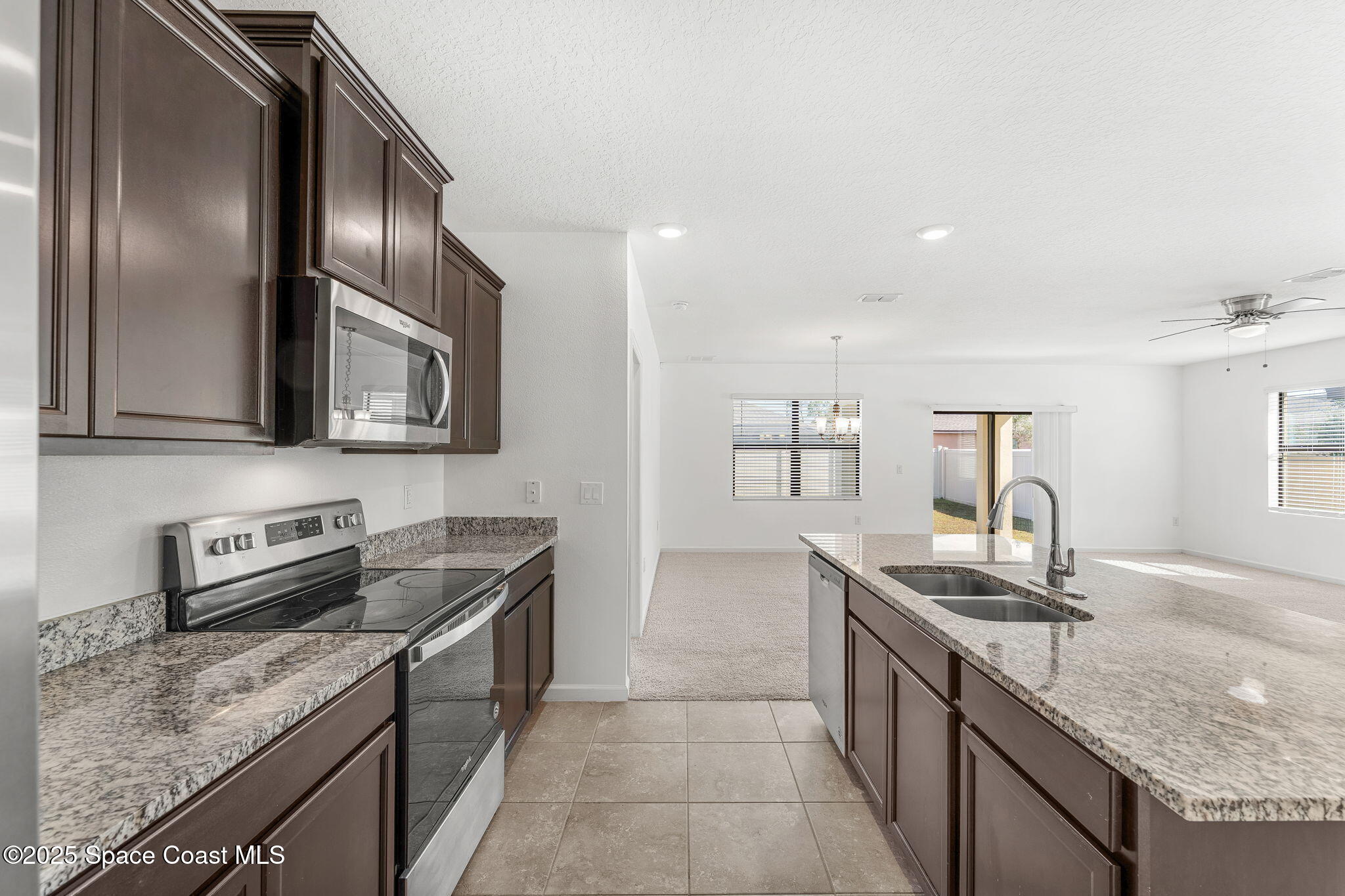 4667 Magenta Isles Drive Melbourne, FL 32904 - Photo 7 of 29 a kitchen with granite countertop stainless steel appliances and sink