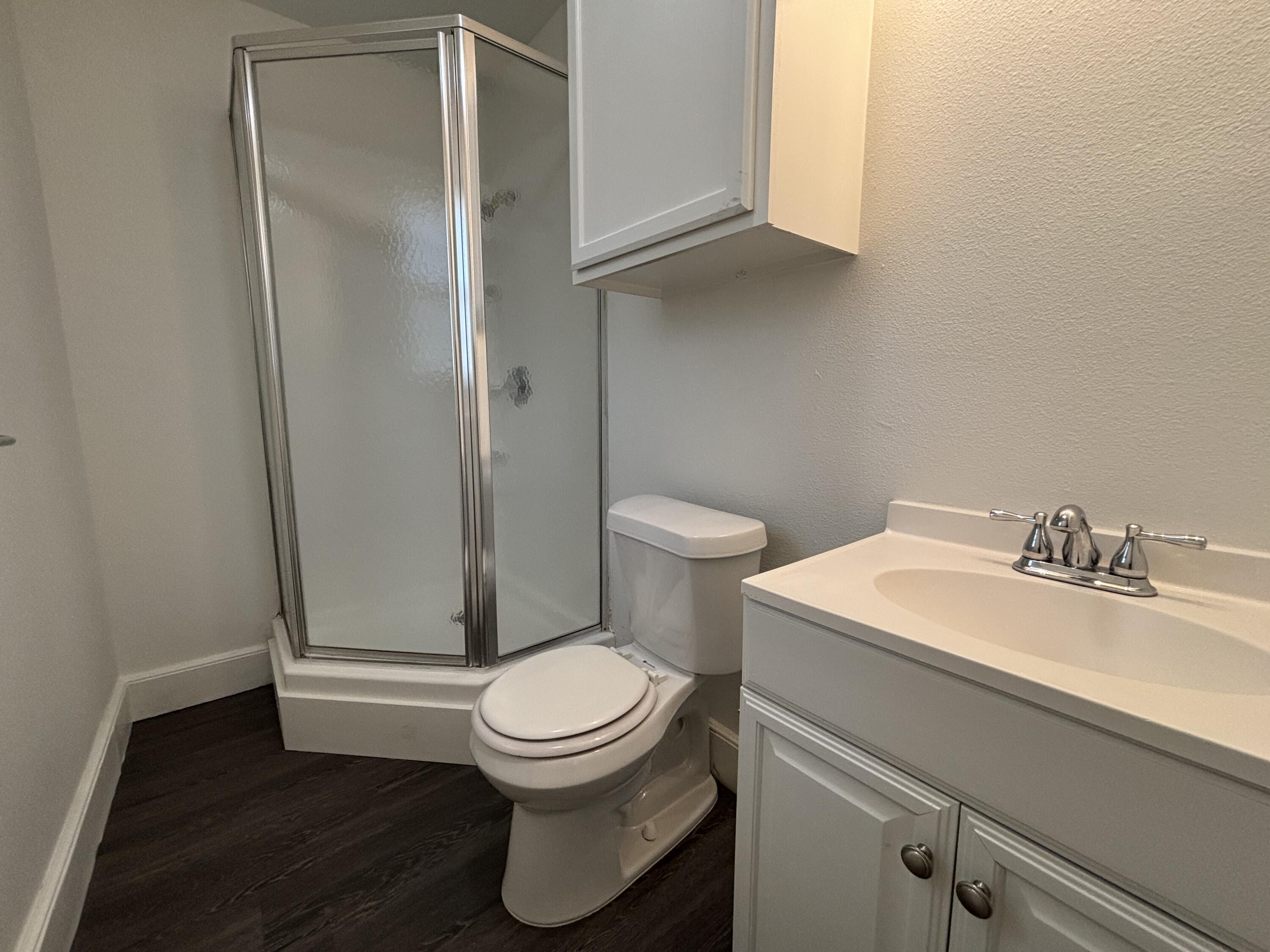 7406 Globe Avenue Lubbock, TX 79404 - Photo 7 of 10 a white toilet sitting next to a bathroom sink