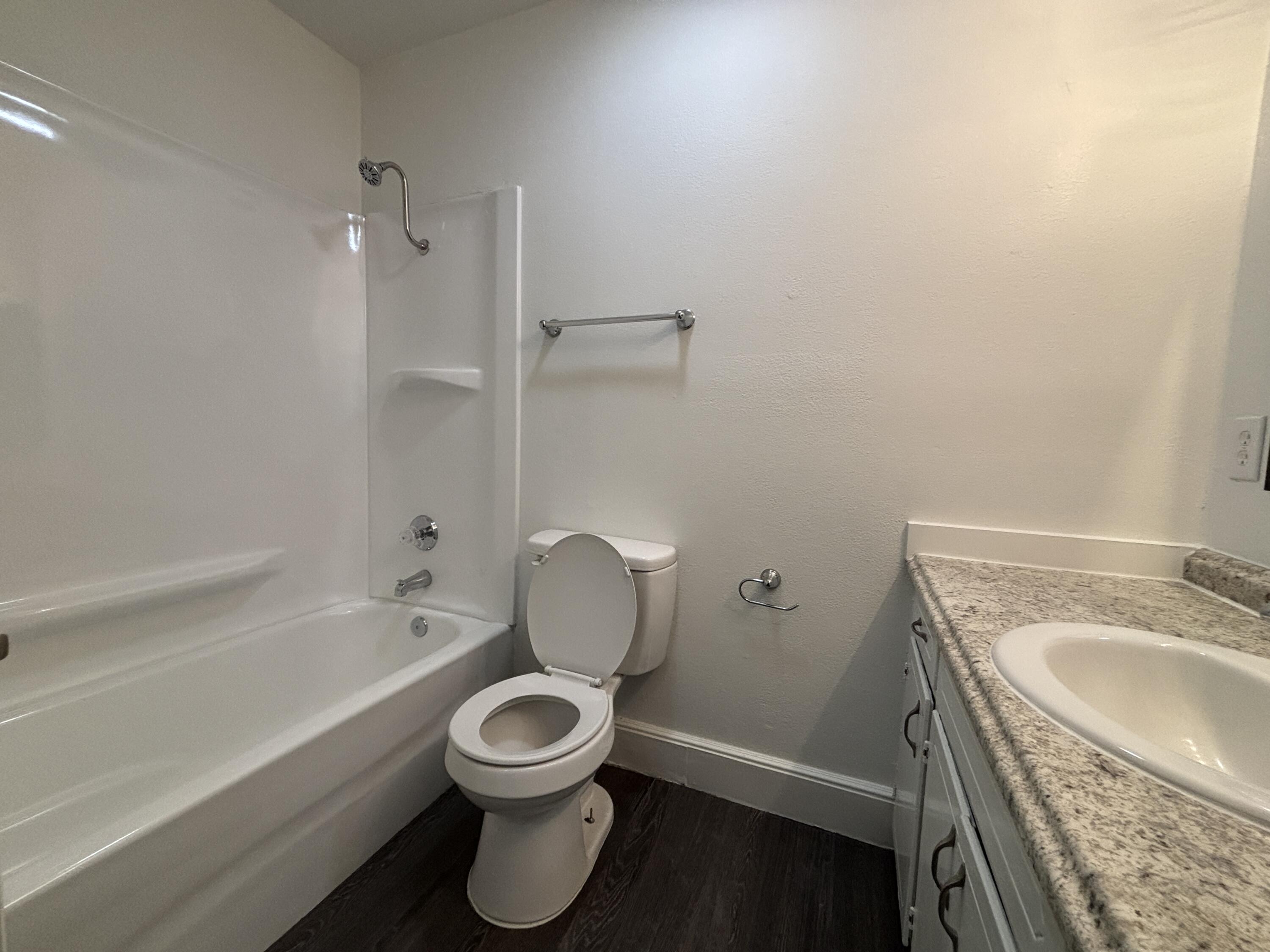 7406 Globe Avenue Lubbock, TX 79404 - Photo 10 of 10 a bathroom with a sink a toilet and bathtub