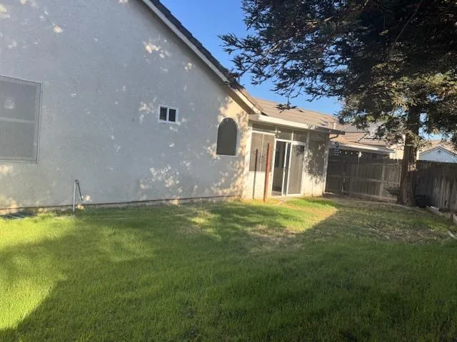a backyard of a house with table and chairs