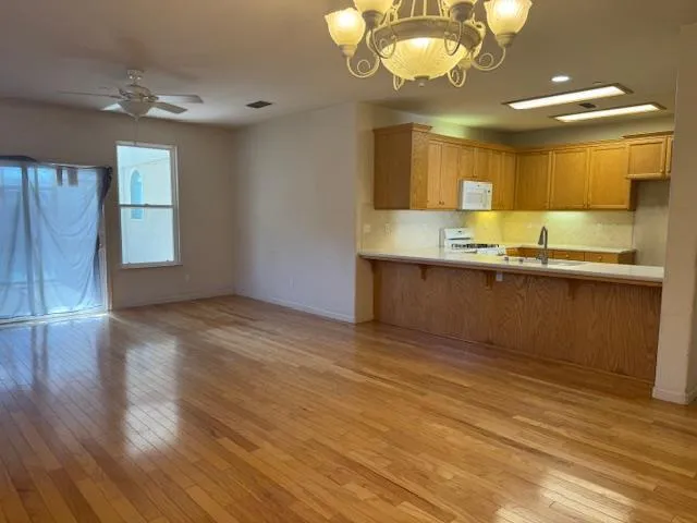 a view of a kitchen counter space and wooden floor