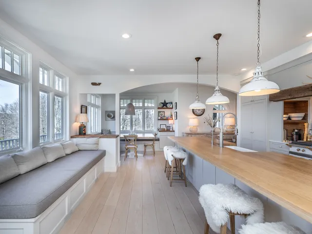 a large kitchen with a large window and stainless steel appliances