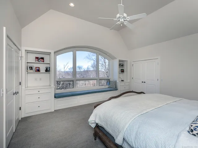a spacious bedroom with a large bed and a large window
