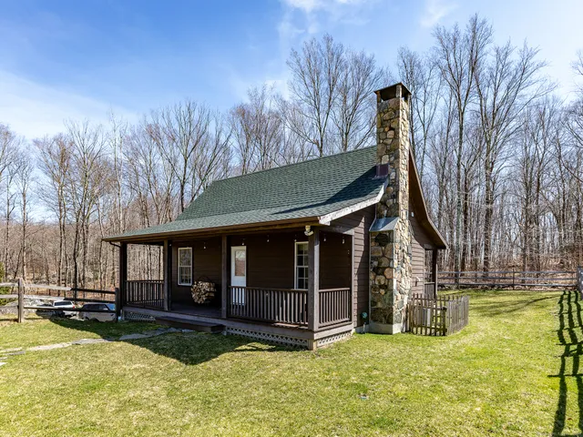 a view of a house with backyard porch and sitting area