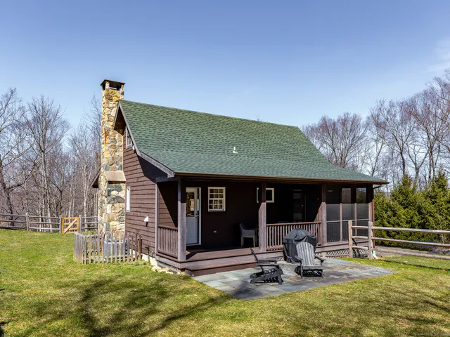 a view of a house with backyard porch and sitting area