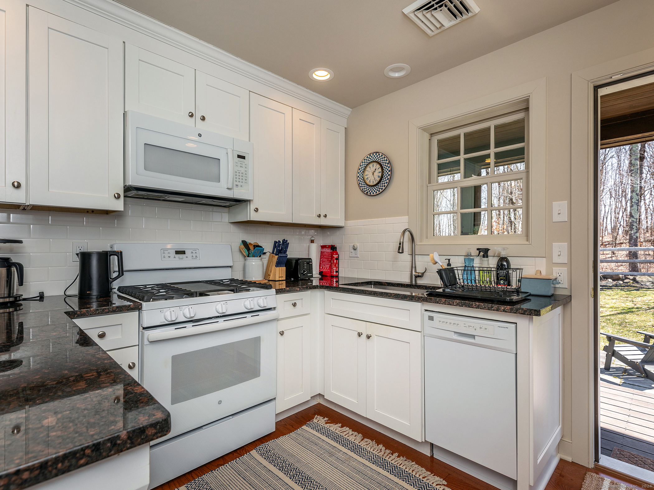 96 Kinney Hill Road New Preston Marble Dale, CT 06777 - Photo 32 of 36 a kitchen with granite countertop white cabinets and white appliances