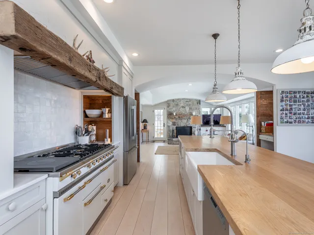 a kitchen with stainless steel appliances granite countertop a stove and cabinets