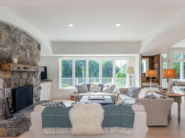 a living room with fireplace furniture and a fireplace
