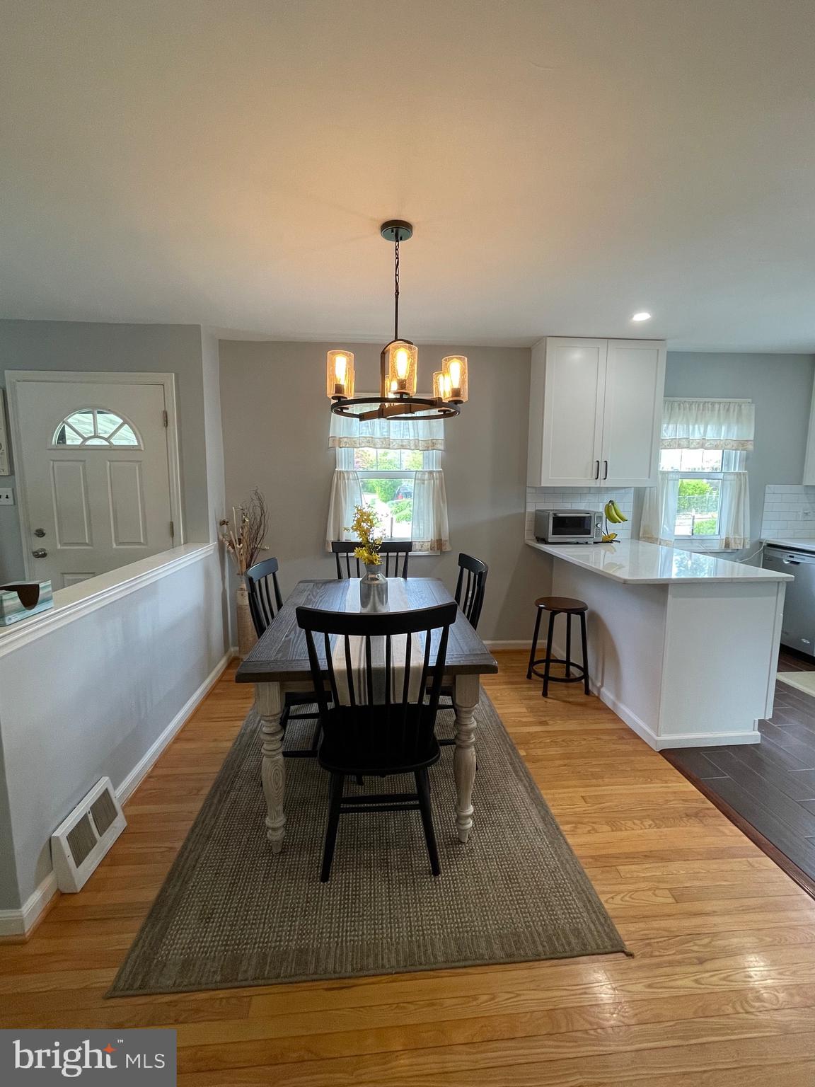 16 Ridgley Street Mount Holly, NJ 08060 - Photo 17 of 29 a dining room with furniture a chandelier and wooden floor