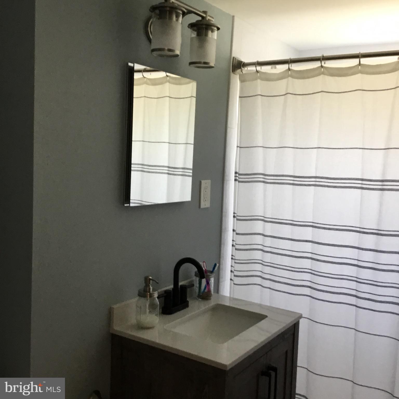 16 Ridgley Street Mount Holly, NJ 08060 - Photo 23 of 29 a bathroom with a sink and a mirror