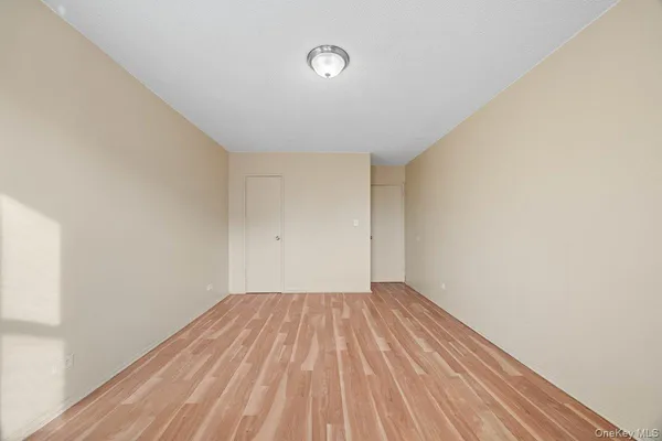 a bedroom with bed and a potted plant
