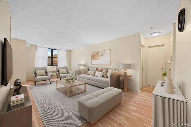 a living room with furniture wooden floor and a flat screen tv