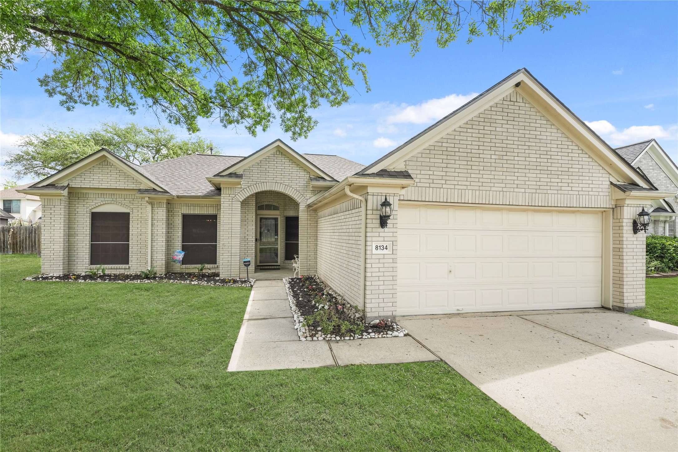 8134 Blue Jay Street Baytown, TX 77523 - Photo 2 of 31 This charming white brick home offers exceptional curb appeal, highlighted by a welcoming walkway that leads you through beautifully maintained landscaping. Lush greenery, manicured beds, and thoughtful design create a warm and inviting first impression, setting the tone for the quality found throughout the property.