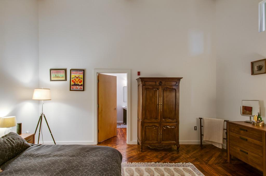 1350 Rosa L Parks Boulevard, Unit 340 Nashville, TN 37208 - Photo 7 of 18 a bedroom with a bed and furniture