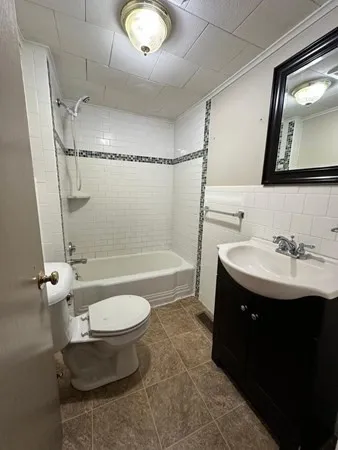 a bathroom with a sink toilet a mirror and shower