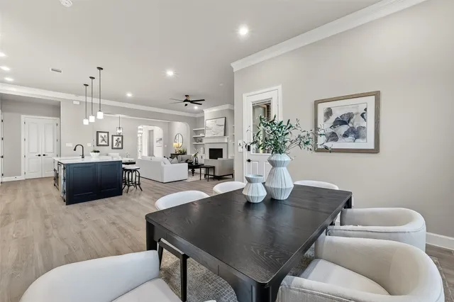 a kitchen with stainless steel appliances granite countertop a sink a stove and a wooden floors