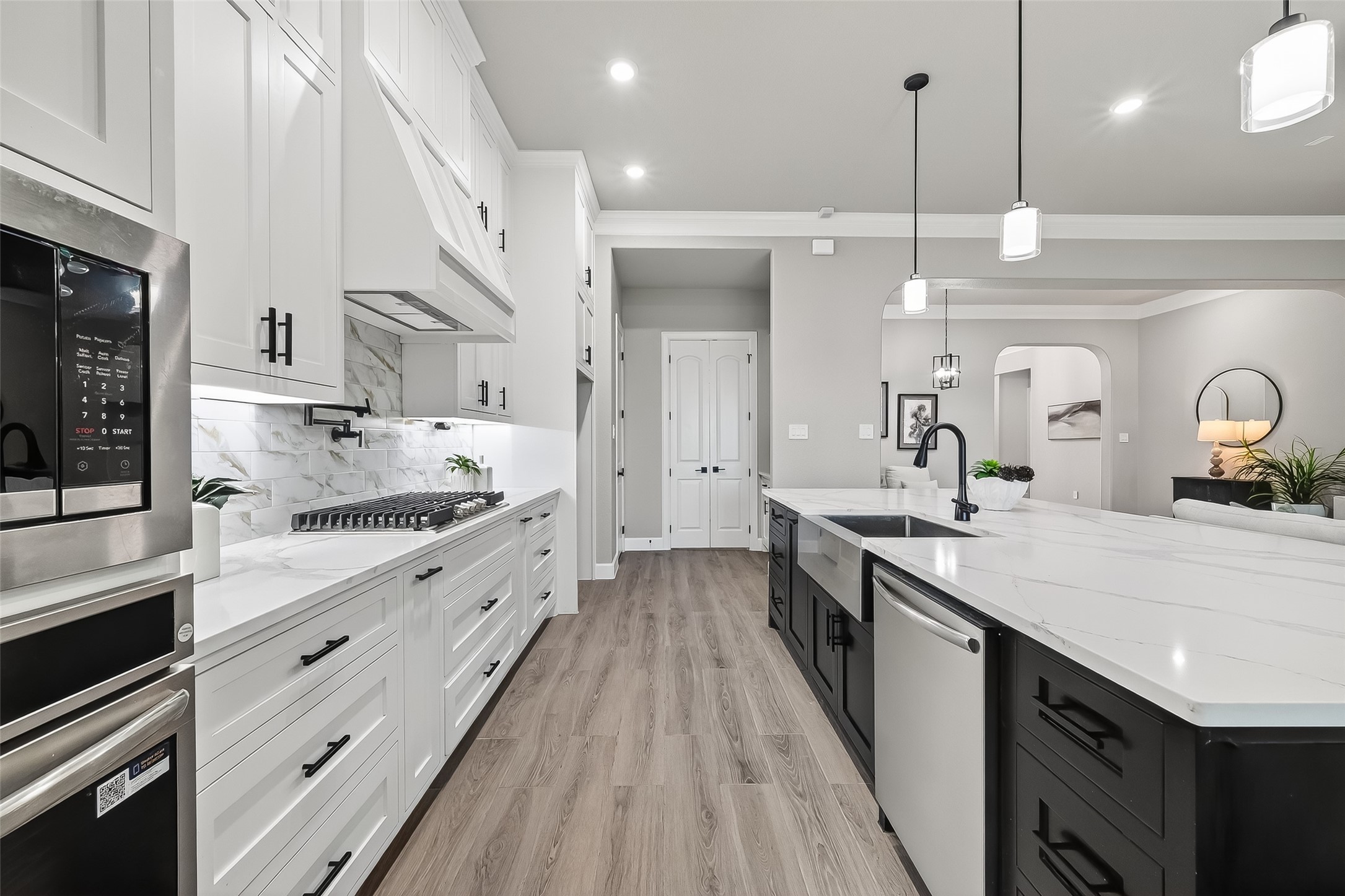 350 Lakeland Circle Rosharon, TX 77583 - Photo 14 of 49 a large kitchen with stainless steel appliances kitchen island granite countertop a lot of counter space and wooden floor