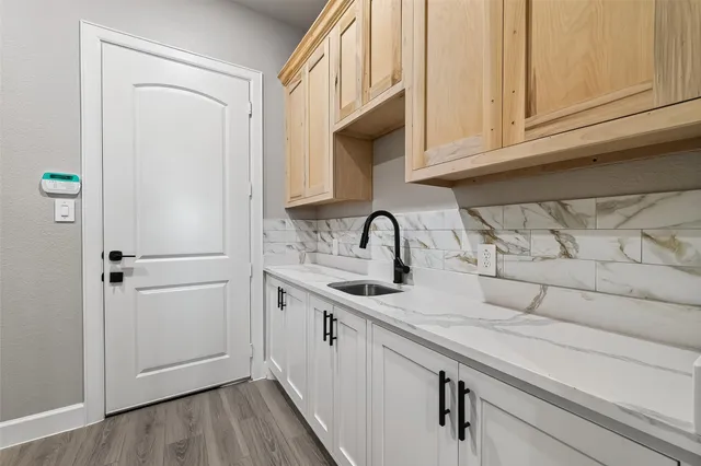 a view of an empty room with a fireplace and a window