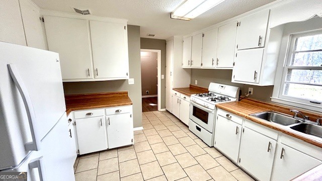 13 Eugenia Circle Rome, GA 30165 - Photo 13 of 19 a kitchen with white cabinets and white appliances