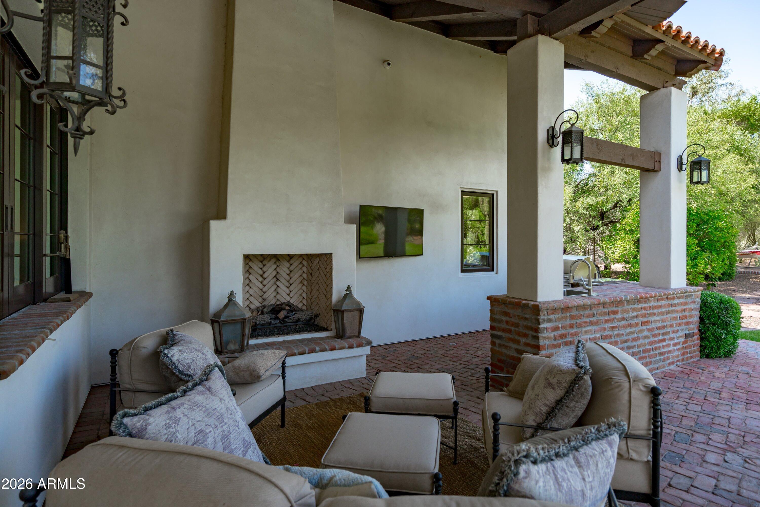 5434 East Camel Hill Road Phoenix, AZ 85018 - Photo 105 of 147 a living room with furniture and a fireplace