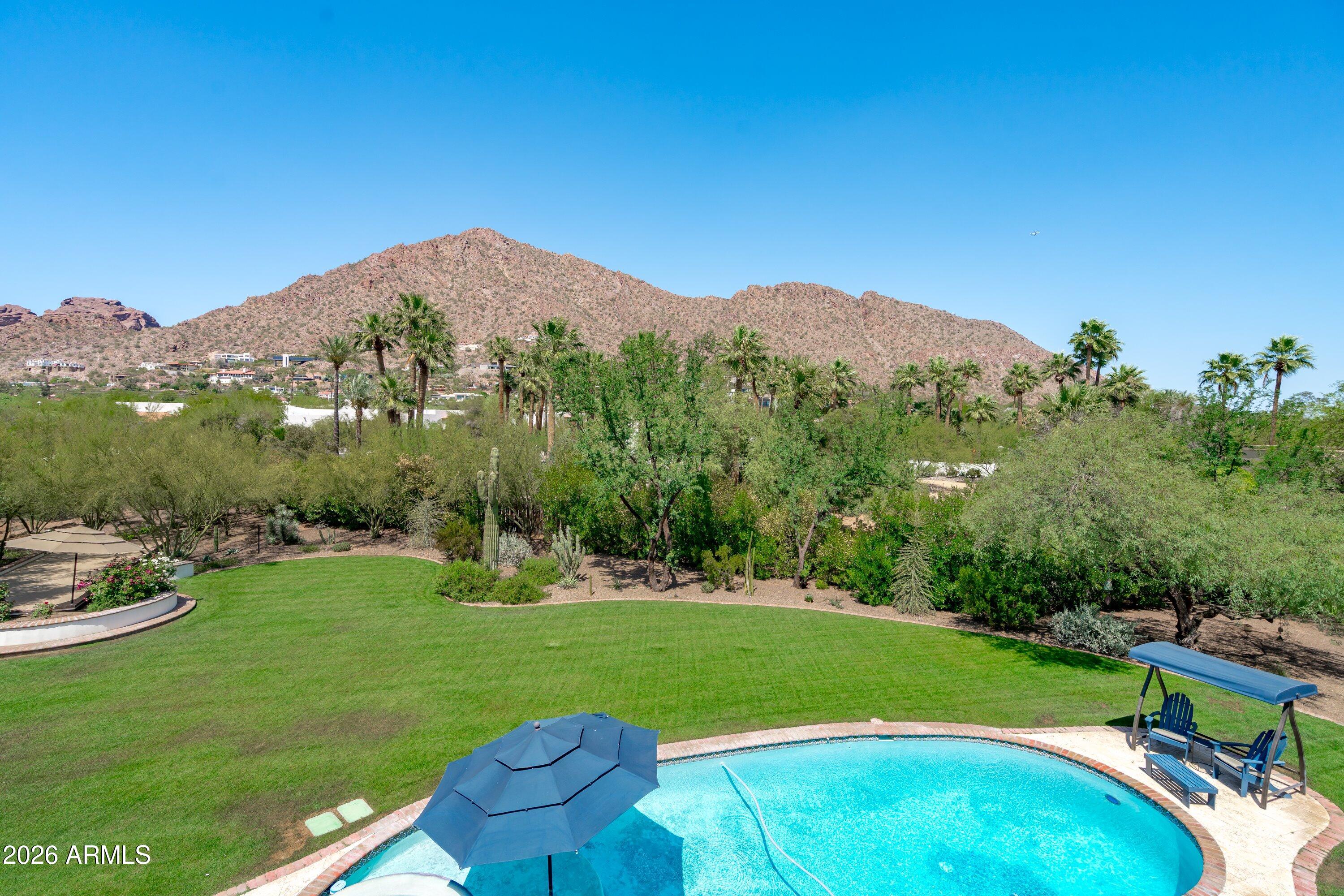 5434 East Camel Hill Road Phoenix, AZ 85018 - Photo 112 of 147 a view of a grassy field with mountains in the background