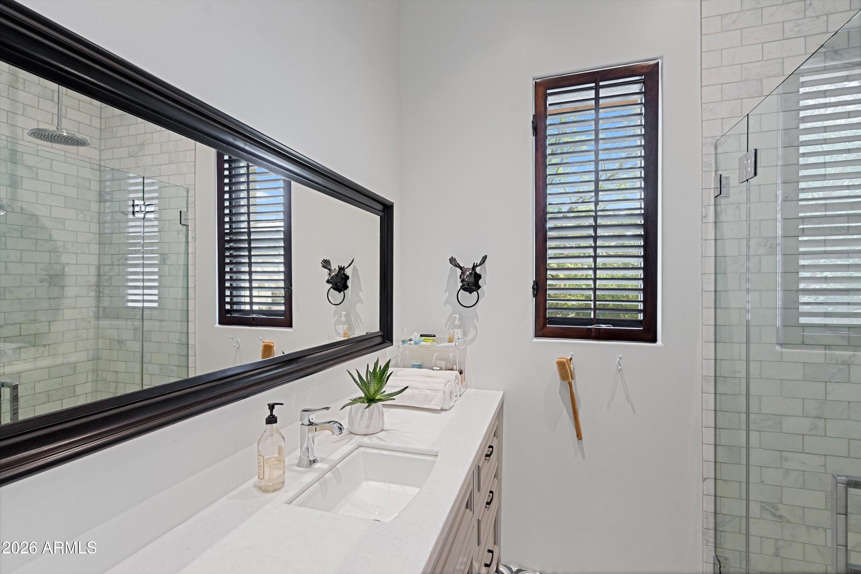 5434 East Camel Hill Road Phoenix, AZ 85018 - Photo 70 of 147 a bathroom with a granite countertop sink and a large mirror