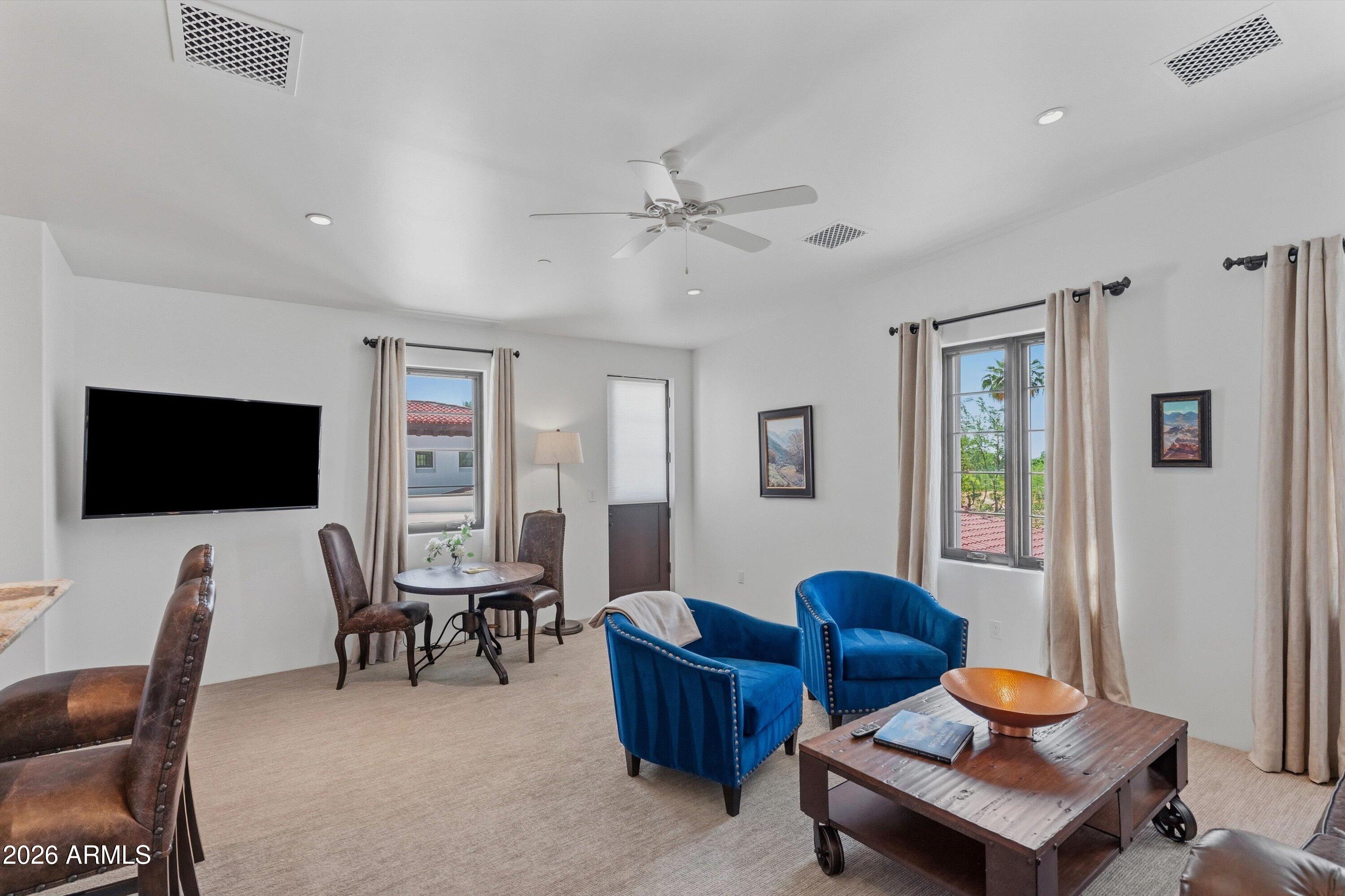 5434 East Camel Hill Road Phoenix, AZ 85018 - Photo 82 of 147 a living room with furniture a flat screen tv and kitchen view