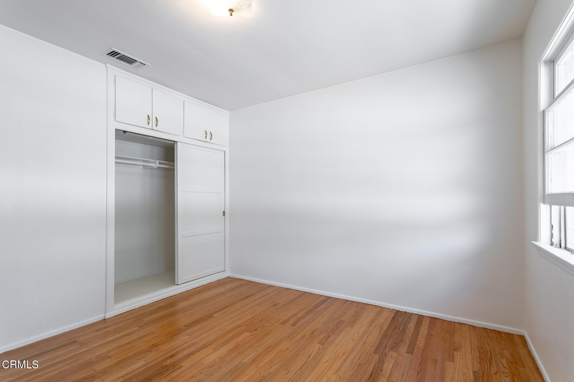 890 Arwin Street Pasadena, CA 91103 - Photo 11 of 40 a view of an empty room with wooden floor and a window