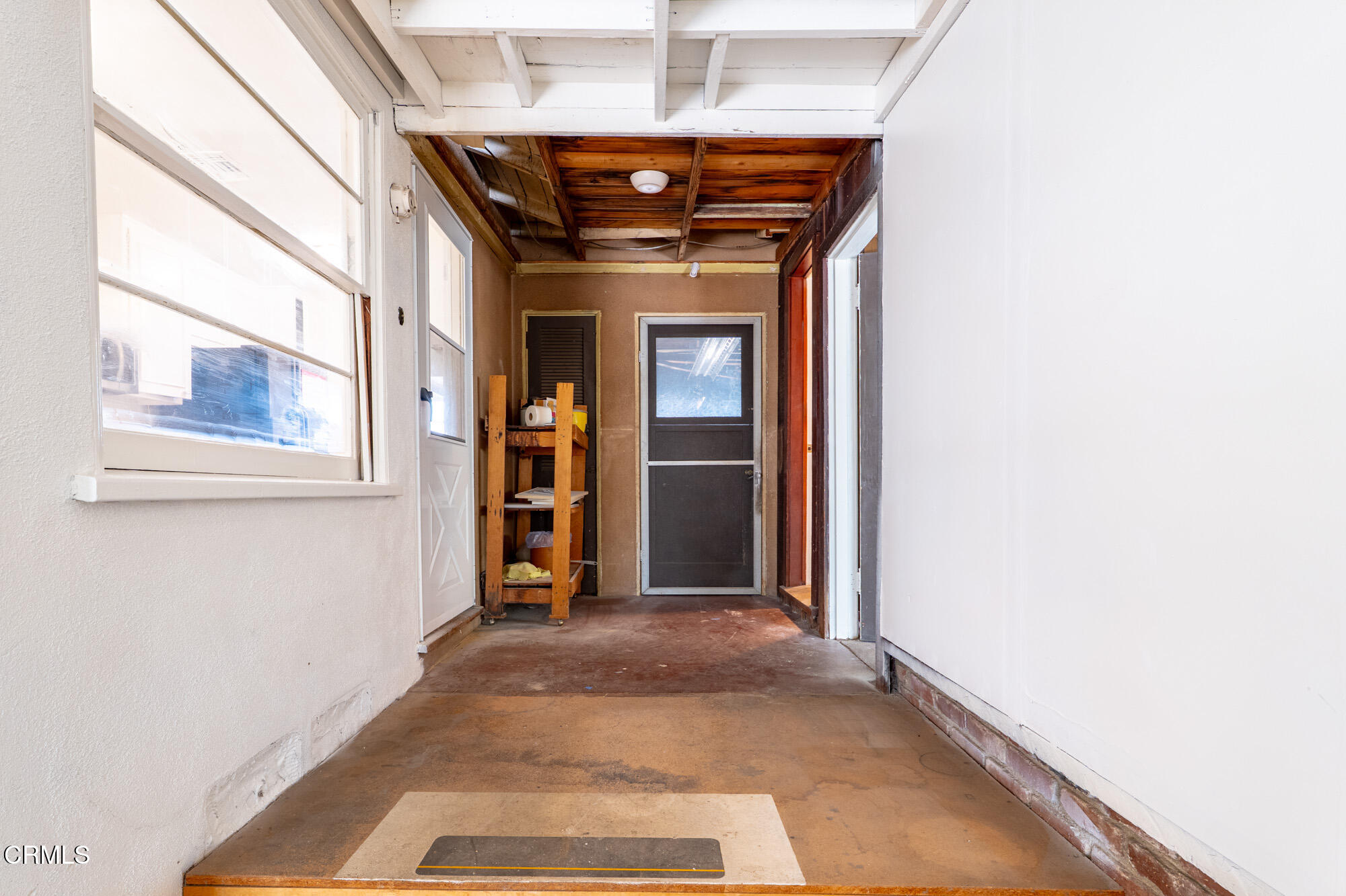 890 Arwin Street Pasadena, CA 91103 - Photo 22 of 40 a view of a hallway with wooden shelves