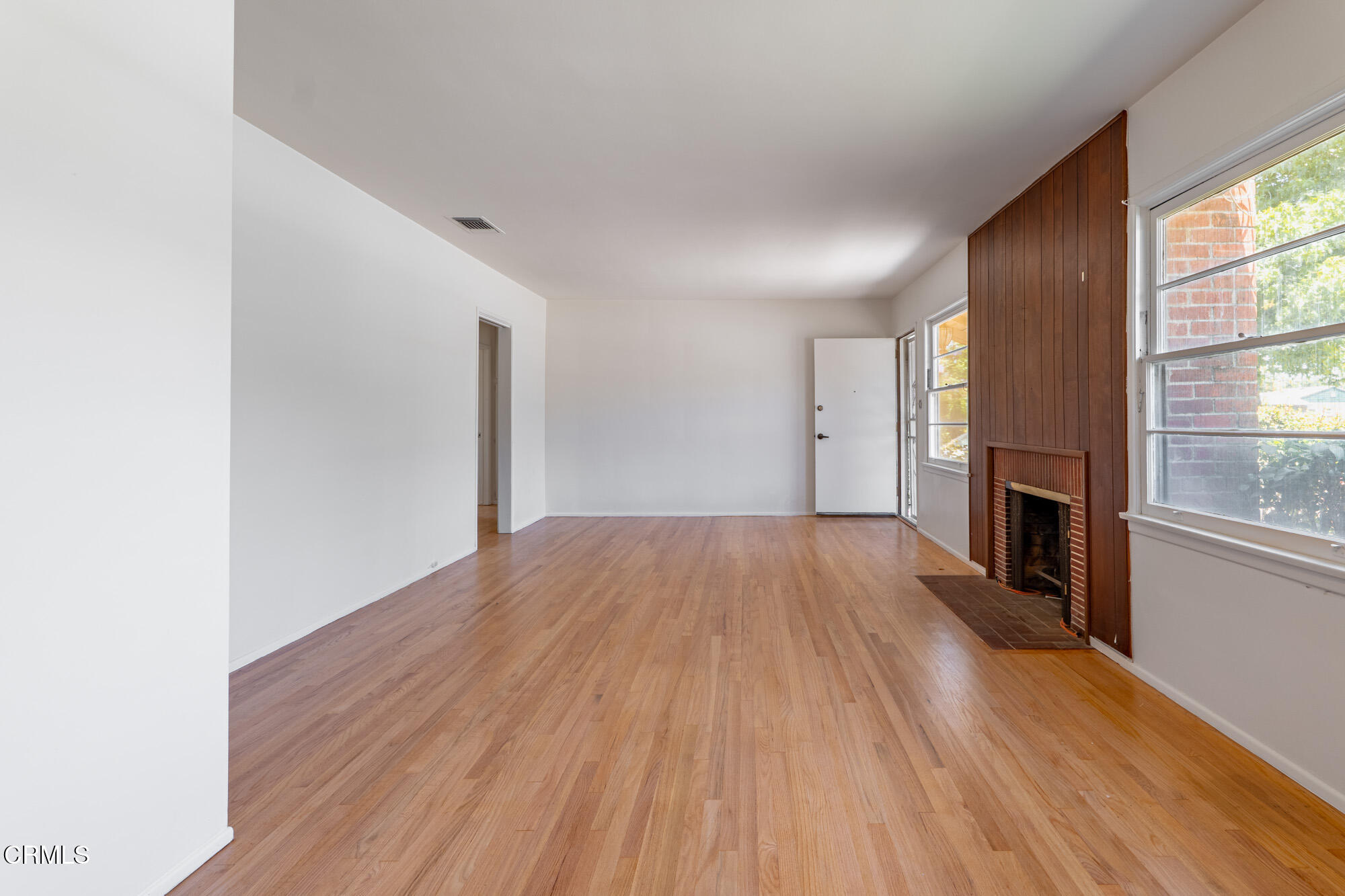 890 Arwin Street Pasadena, CA 91103 - Photo 5 of 40 a view of empty room with wooden floor and fireplace