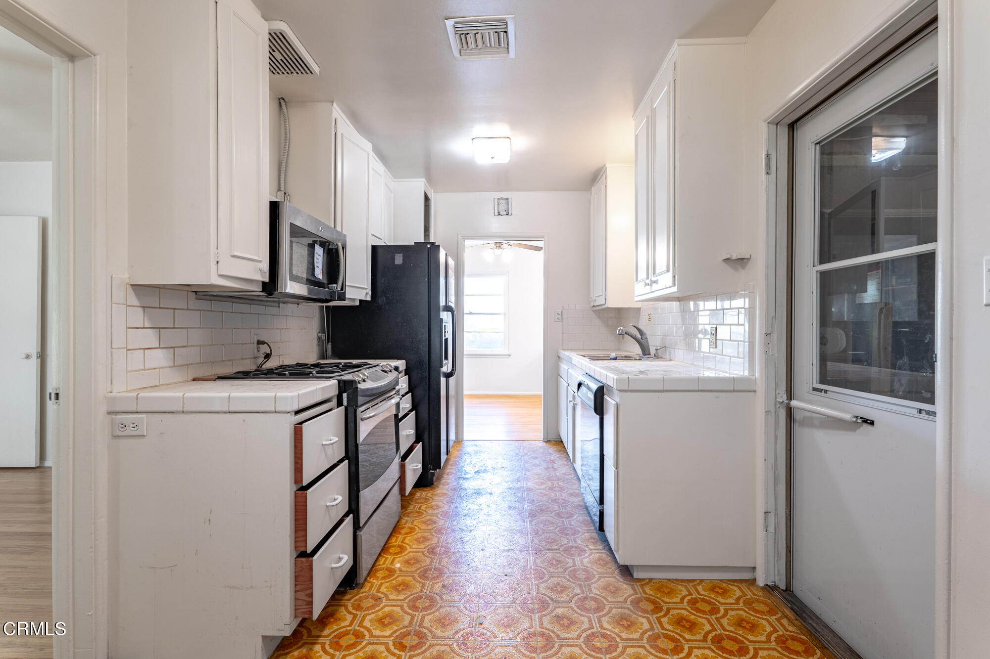 890 Arwin Street Pasadena, CA 91103 - Photo 6 of 40 a kitchen with a refrigerator a sink and wooden floor
