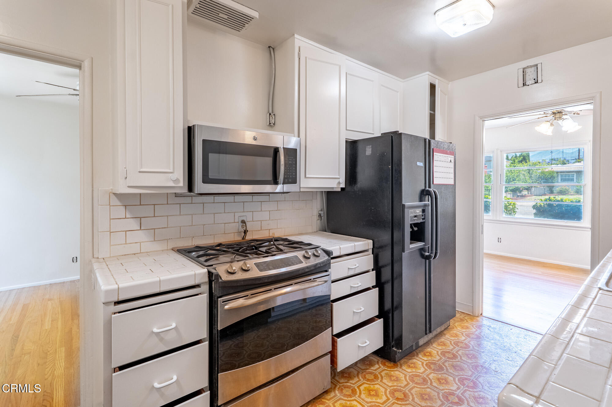 890 Arwin Street Pasadena, CA 91103 - Photo 7 of 40 a kitchen with stainless steel appliances granite countertop a refrigerator stove and microwave