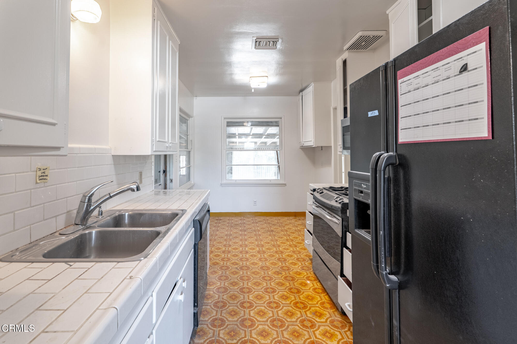 890 Arwin Street Pasadena, CA 91103 - Photo 8 of 40 a kitchen that has a sink and a stove